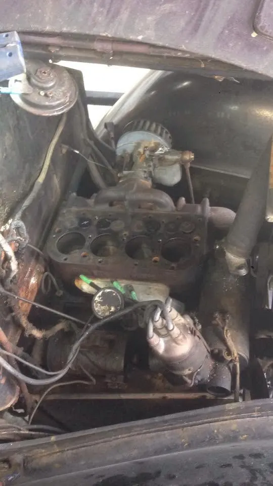 Engine bay of a classic car being worked on at Autotech
